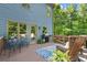 Home's outdoor deck featuring wood flooring, a patio set, a grill, and wooded views at 2660 Burnt Hickory Dr, Cumming, GA 30028
