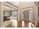 Bright foyer with hardwood floors and modern front door leading to a living area with large windows and an elegant ceiling at 2660 Burnt Hickory Dr, Cumming, GA 30028