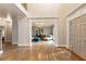 Open concept foyer with hardwood floors and modern front door leading to a living area with lots of light and ample space at 2660 Burnt Hickory Dr, Cumming, GA 30028