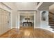 Open foyer featuring a dining room, staircase, front door, hardwood floors, and elegant moldings with ample light at 2660 Burnt Hickory Dr, Cumming, GA 30028