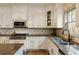 Modern kitchen showcasing granite countertops, white cabinets, and stainless-steel appliances at 2660 Burnt Hickory Dr, Cumming, GA 30028