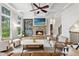 Spacious living room featuring a stone fireplace, built-in shelving, and abundant natural light at 2660 Burnt Hickory Dr, Cumming, GA 30028