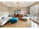 Bright living room featuring hardwood floors, coffered ceilings, ample natural light, and neutral-toned modern furniture at 2660 Burnt Hickory Dr, Cumming, GA 30028