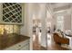 Elegant living room featuring hardwood floors, wine rack, and seamlessly connected to kitchen at 2660 Burnt Hickory Dr, Cumming, GA 30028