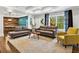 Comfortable living room with neutral furnishings and an open view to the game room at 2660 Burnt Hickory Dr, Cumming, GA 30028