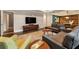 Open-concept living room featuring hardwood floors, coffered ceilings, recessed lights, and stylish furniture at 2660 Burnt Hickory Dr, Cumming, GA 30028