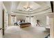 Spacious main bedroom with tray ceiling, windows and carpeted floors at 2660 Burnt Hickory Dr, Cumming, GA 30028