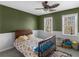 Cozy bedroom with two windows, a patterned bedspread, and a ceiling fan at 526 Lakeside Dr, Hiram, GA 30141