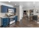 Well-equipped kitchen with blue cabinetry, stainless appliances, open to the dining area at 526 Lakeside Dr, Hiram, GA 30141