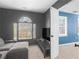 Relaxing living room with a large window, gray sofa, and neutral decor at 526 Lakeside Dr, Hiram, GA 30141