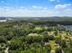Panoramic aerial view showcasing lush greenery, landscape, and water features at 6637 Oak Farm Se Dr, Acworth, GA 30102
