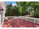 Inviting outdoor space with a painted deck, white railing, and scenic wooded views provides great privacy at 6637 Oak Farm Se Dr, Acworth, GA 30102
