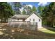 Spacious backyard featuring a wooden deck, manicured lawn, and the home exterior with white siding at 6637 Oak Farm Se Dr, Acworth, GA 30102