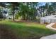 Expansive backyard features lush greenery, a well-maintained lawn, and a house with a large deck at 6637 Oak Farm Se Dr, Acworth, GA 30102