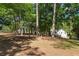 Lush backyard area with towering trees providing shade to the home and lawn at 6637 Oak Farm Se Dr, Acworth, GA 30102