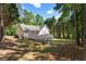 Charming home backyard featuring a spacious yard with mature trees, partial fencing, and large deck at 6637 Oak Farm Se Dr, Acworth, GA 30102