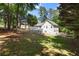 Well-maintained backyard with lush green grass, mature trees, and a house with a large wooden deck at 6637 Oak Farm Se Dr, Acworth, GA 30102