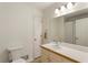 Well-lit bathroom featuring a sink, toilet, a large mirror, and tile flooring at 6637 Oak Farm Se Dr, Acworth, GA 30102