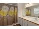 Bathroom featuring double sinks, a floral shower curtain, white cabinets, and modern lighting at 6637 Oak Farm Se Dr, Acworth, GA 30102
