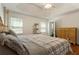 Bedroom boasting wood floors, large windows, an antique dresser, and a decorative metal bed frame at 6637 Oak Farm Se Dr, Acworth, GA 30102
