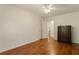 Bedroom with wood flooring, neutral walls, and a dark wood dresser with mirror at 6637 Oak Farm Se Dr, Acworth, GA 30102