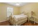 Bedroom featuring bright yellow walls, wood floors, a ceiling fan, and a decorative metal bed frame at 6637 Oak Farm Se Dr, Acworth, GA 30102