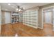 Spacious bonus room with custom shelving, hardwood floors, and multiple entryways at 6637 Oak Farm Se Dr, Acworth, GA 30102