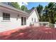The back of the home has a large red stained deck for enjoying the private wooded lot at 6637 Oak Farm Se Dr, Acworth, GA 30102