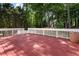 Stained deck with white railing overlooks the wooded property, offering serene outdoor space at 6637 Oak Farm Se Dr, Acworth, GA 30102