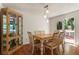 Well-lit dining area with wood floors, modern light fixture, cabinet, and access to an outdoor deck at 6637 Oak Farm Se Dr, Acworth, GA 30102