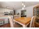 Open dining area featuring hardwood floors, a modern light fixture and an open flow into the kitchen at 6637 Oak Farm Se Dr, Acworth, GA 30102