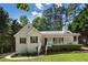 Charming one-story home with a covered front porch, a well-maintained lawn, and mature trees at 6637 Oak Farm Se Dr, Acworth, GA 30102