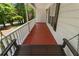 Charming covered porch features stained wood flooring and a swing overlooking the wooded front yard at 6637 Oak Farm Se Dr, Acworth, GA 30102