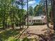 Traditional home with a well-manicured lawn, mature trees, and classic architectural details at 6637 Oak Farm Se Dr, Acworth, GA 30102