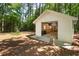 Detached garage with a white exterior, open door, and an NHRA banner hanging inside the space at 6637 Oak Farm Se Dr, Acworth, GA 30102