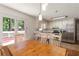 View of the eat-in kitchen with stainless appliances, white cabinets, and access to the outdoor deck at 6637 Oak Farm Se Dr, Acworth, GA 30102