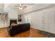 Inviting living room featuring a fireplace, built-in shelves, and a ceiling fan with hardwood floors at 6637 Oak Farm Se Dr, Acworth, GA 30102