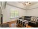 Bright living room with hardwood floors, a large window, and a stylish couch with decorative pillows at 6637 Oak Farm Se Dr, Acworth, GA 30102