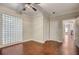 Spacious bedroom featuring hardwood floors, crown molding, and a glass block wall feature at 2161 Peachtree Rd # Apt 706, Atlanta, GA 30309