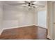 Bright bedroom featuring hardwood floors, modern fan, and unique glass block window at 2161 Peachtree Rd # Apt 706, Atlanta, GA 30309