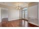 Dining room features hardwood floors, classic chandelier, and French doors to the balcony at 2161 Peachtree Rd # Apt 706, Atlanta, GA 30309
