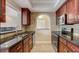 Kitchen view featuring dark wood cabinets, stainless steel appliances, and a granite countertop at 2161 Peachtree Rd # Apt 706, Atlanta, GA 30309
