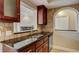 Cozy kitchen featuring dark wood cabinets, stainless steel appliances, and a granite countertop at 2161 Peachtree Rd # Apt 706, Atlanta, GA 30309