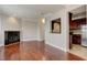 Spacious living room with hardwood floors, fireplace, and kitchen pass-through at 2161 Peachtree Rd # Apt 706, Atlanta, GA 30309