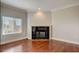 Cozy living room featuring hardwood floors, fireplace, and bright window overlooking city at 2161 Peachtree Rd # Apt 706, Atlanta, GA 30309