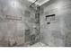 Luxurious bathroom features a slate tiled shower with mosaic tile floor and built in niche at 2161 Peachtree Rd # Apt 706, Atlanta, GA 30309