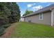 The property's backyard features a patch of grass, trees, and an AC unit at 3020 Meadow Glen Pass, Fairburn, GA 30213