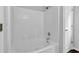 Bathroom showcasing a white tiled tub with a shower at 3020 Meadow Glen Pass, Fairburn, GA 30213