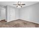 Neutral bedroom with carpet, ceiling fan, and large closet space at 3020 Meadow Glen Pass, Fairburn, GA 30213