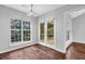 Dining room featuring natural light, French doors, and wood flooring at 3020 Meadow Glen Pass, Fairburn, GA 30213